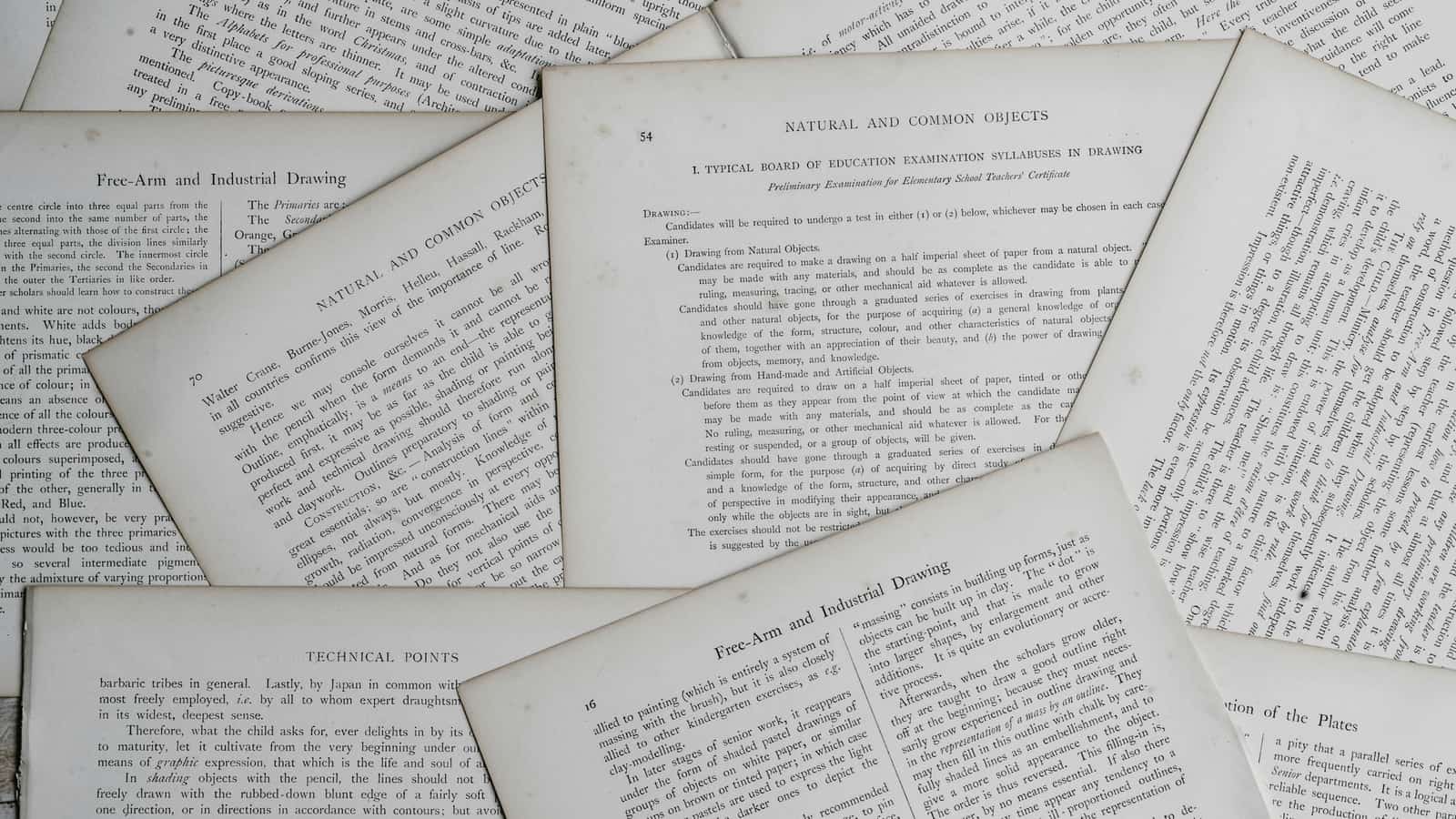 Loose printed pages of typeset text spread out and overlapping on a flat surface